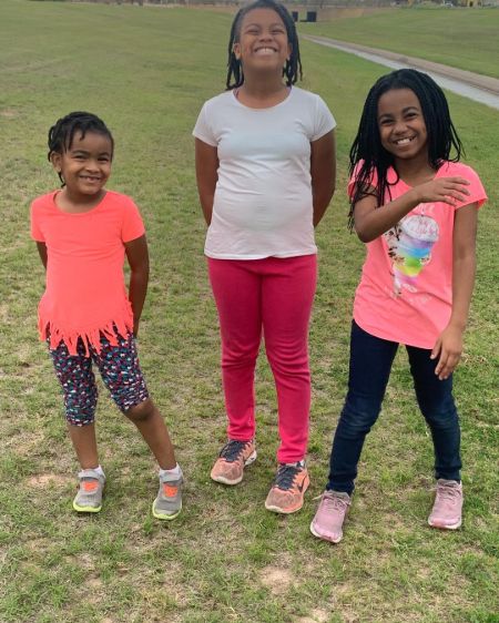 The Clark Sisters's Jacky Clark-Chisholm clicks a photo of her three grandchildren.